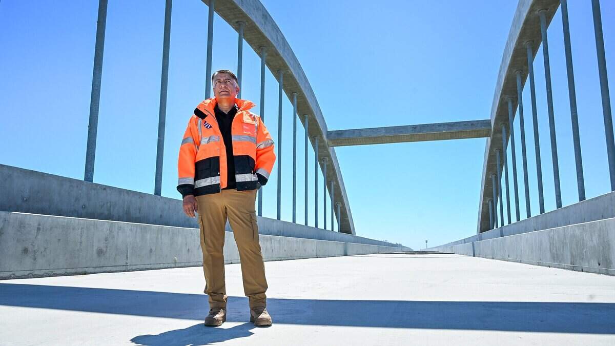 California High-Speed Rail Authority CEO Ian Choudri stands below the archway of the nearly completed San Joaquin River viaduct section of the rail system near Highway 99 between Fresno County and Madera County on Wednesday, June 17, 2026. Cables, tracks and other infrastructure are soon to come, say authorities.