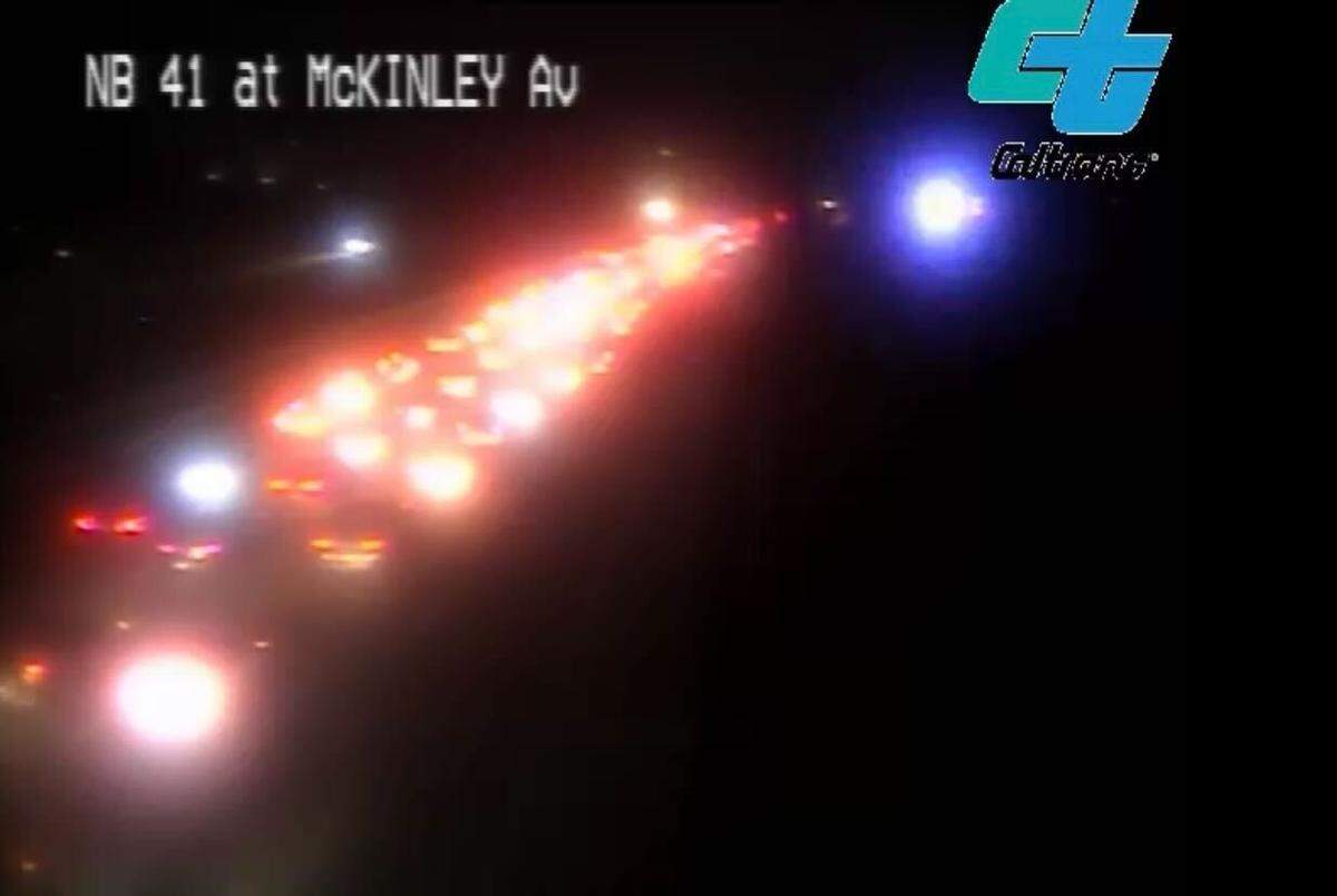 Traffic backed up along Highway 41 near McKinley Avenue after an early Saturday crash that involved a pair of stopped Fresno police cars.