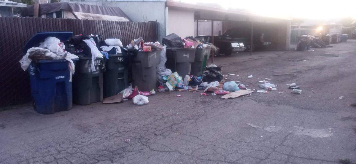 Trash accumulates directly behind the fence of one renter’s apartment;; the renter has sought help from Fresno city Code Enforcement.