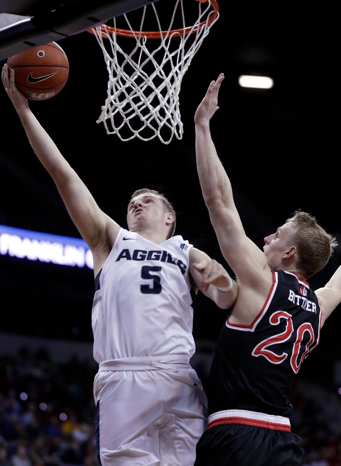 Utah State’s Sam Merrill (5) shoots as Fresno State’s Sam Bittner defends during the first half of an NCAA college basketball game in the Mountain West Conference Tournament Friday, March 15, 2019, in Las Vegas.