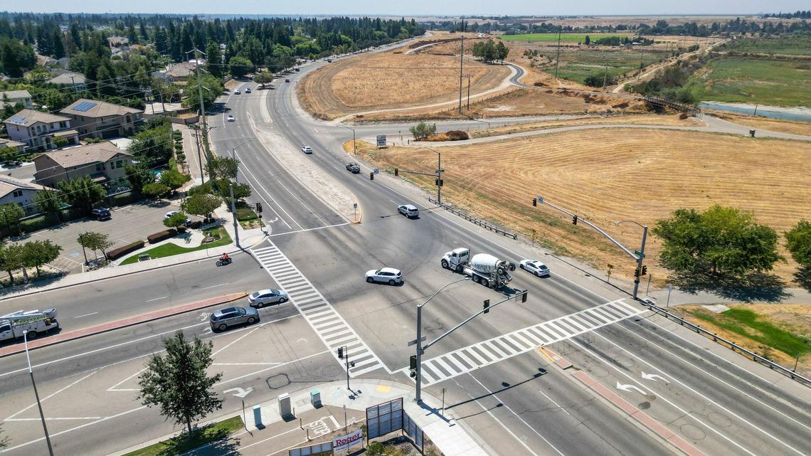 Traffic crosses the intersection at Copper Avenue and Friant Road on Monday, Aug. 5, 2024. Several safety measures have been implemented along a dangerous section of Friant Road in north Fresno including high-visibility crosswalks, reflective signal backplates, and no right turn on red signs.