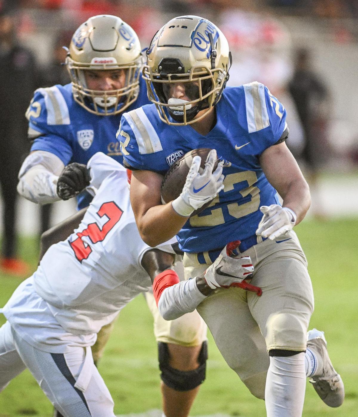 Clovis running back Roman Moreno bursts up the middle on a run against Sanger during their game at Lamonica Stadium in Clovis on Friday, Aug. 25, 2023.