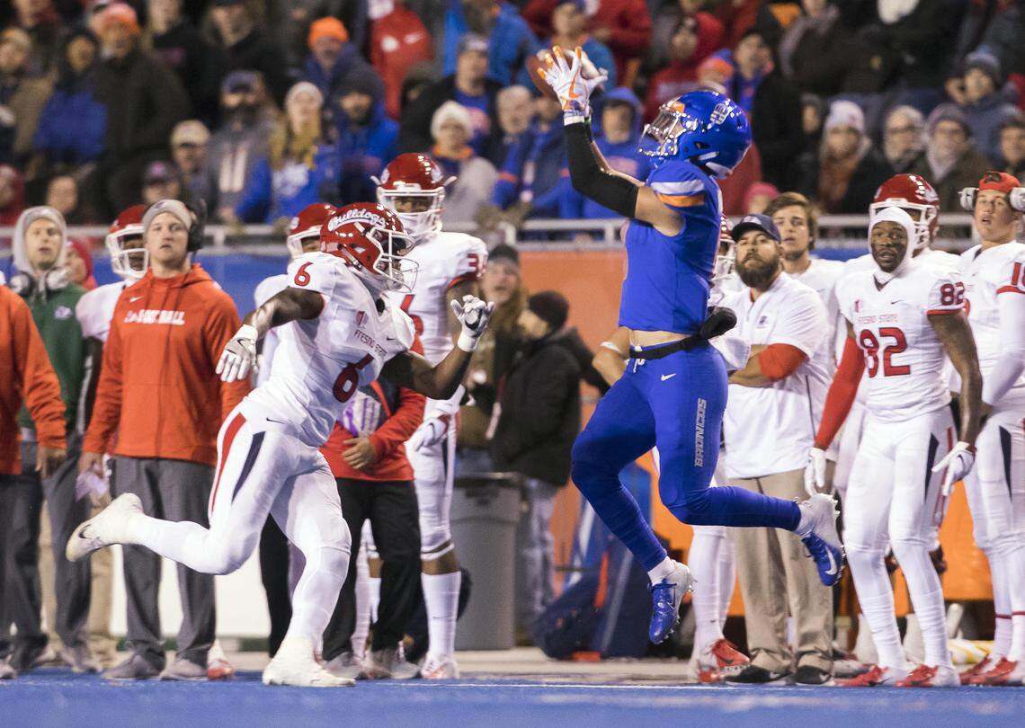 Boise State wide receiver Sean Modster (8) catches the opening-play pass defended by Fresno State defensive back Tank Kelly (6) Friday, Nov. 9, 2018 at Albertsons Stadium in Boise.