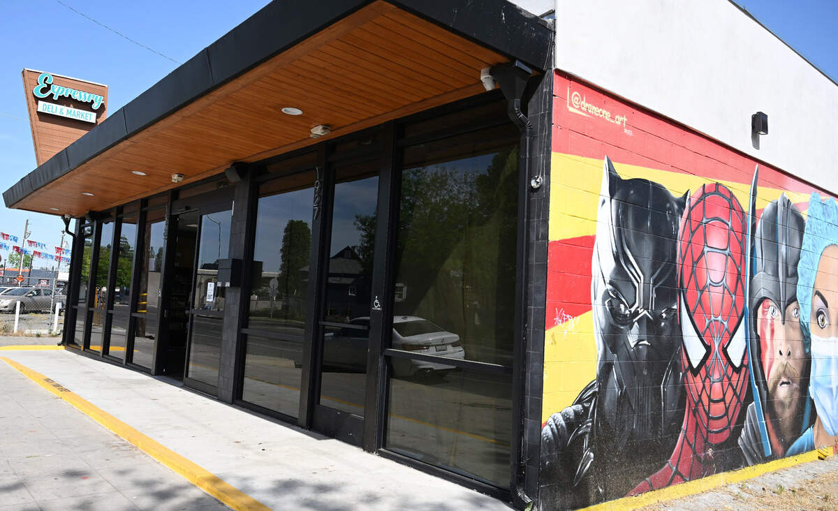 A large mural showing a healthcare worker alongside super heroes is seen outside Akram Mohsin’s Expressry Deli & Market just walking distance from Community Regional Medical Center. Photographed Monday, April 14, 2025 in Fresno.