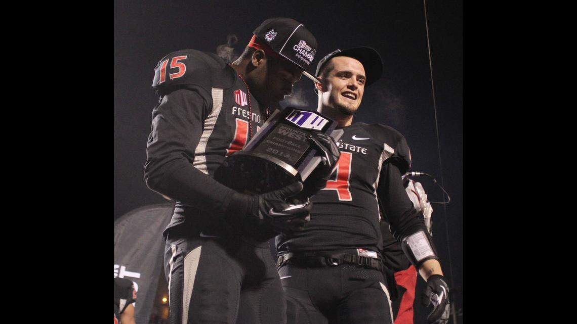 Davante Adams kisses the Mountain West trophy as Derek Carr looks on in the second half of a college football game in Fresno, Calif., Saturday, Dec. 7, 2013. The Las Vegas Raiders acquired Adams from the Green Bay Packers on Thursday, March 17, 2022.