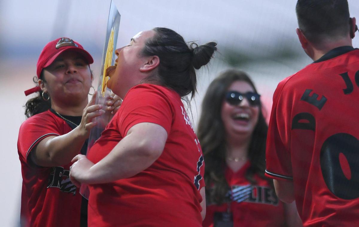 A contestant licks peanut butter during a game between innings for the Fresno Grizzlies 2023 home opener against the Stockton Ports Tuesday, April 11, 2023 in Fresno.