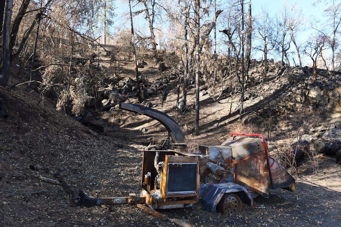 A burned-out wood chipper sits along the old dirt road that firefighters used to access 2020 Creek Fire during its initial hours on the evening of Sept. 4, 2020. This photo was taken Wednesday, Feb. 24, 2021.