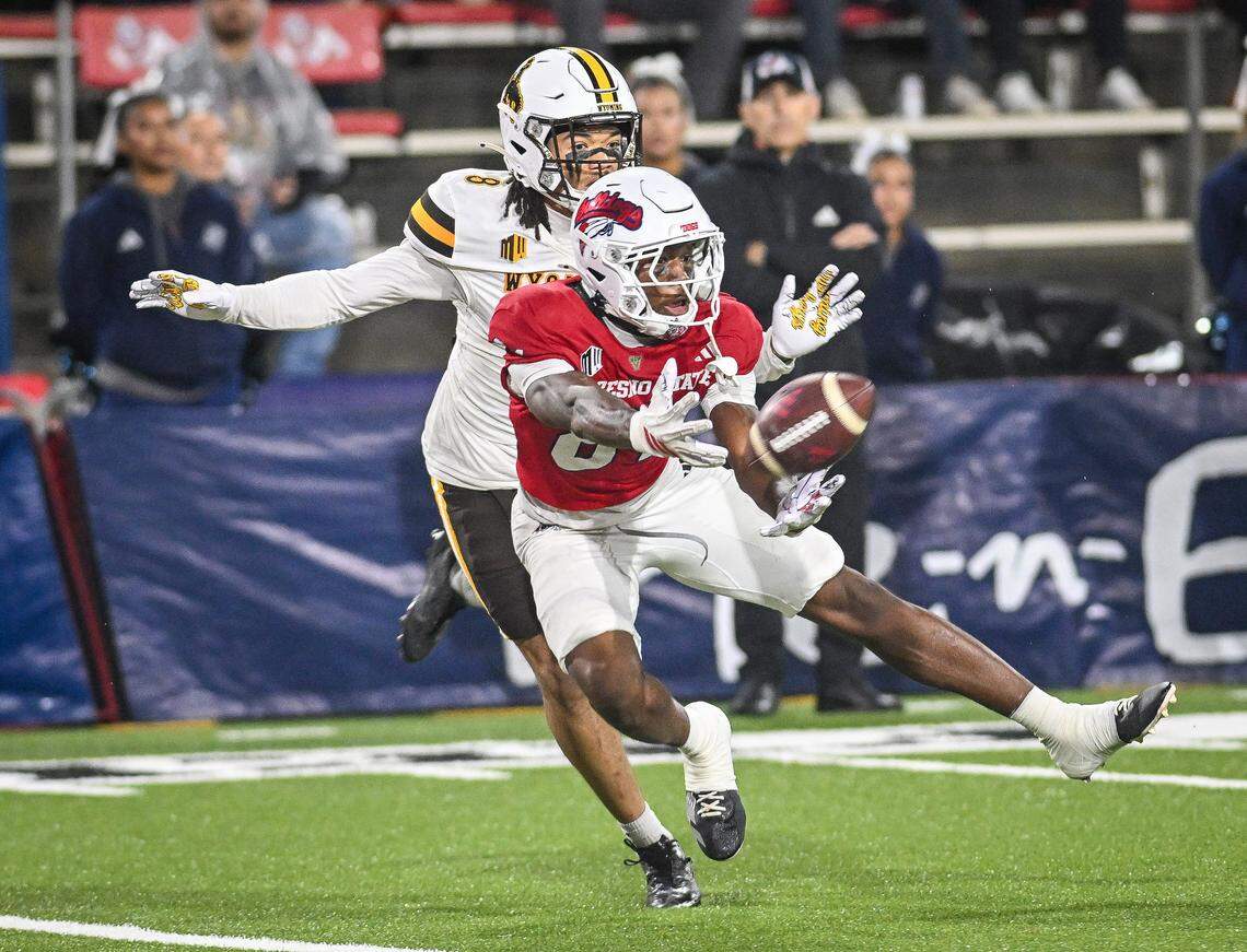 Fresno State’s Ezekiel Avit, nearly comes down with the ball but Wyoming’s Tyrese Boss is called for pass interference during their game at Valley Children’s Stadium on Saturday, Nov. 16, 2025. 
