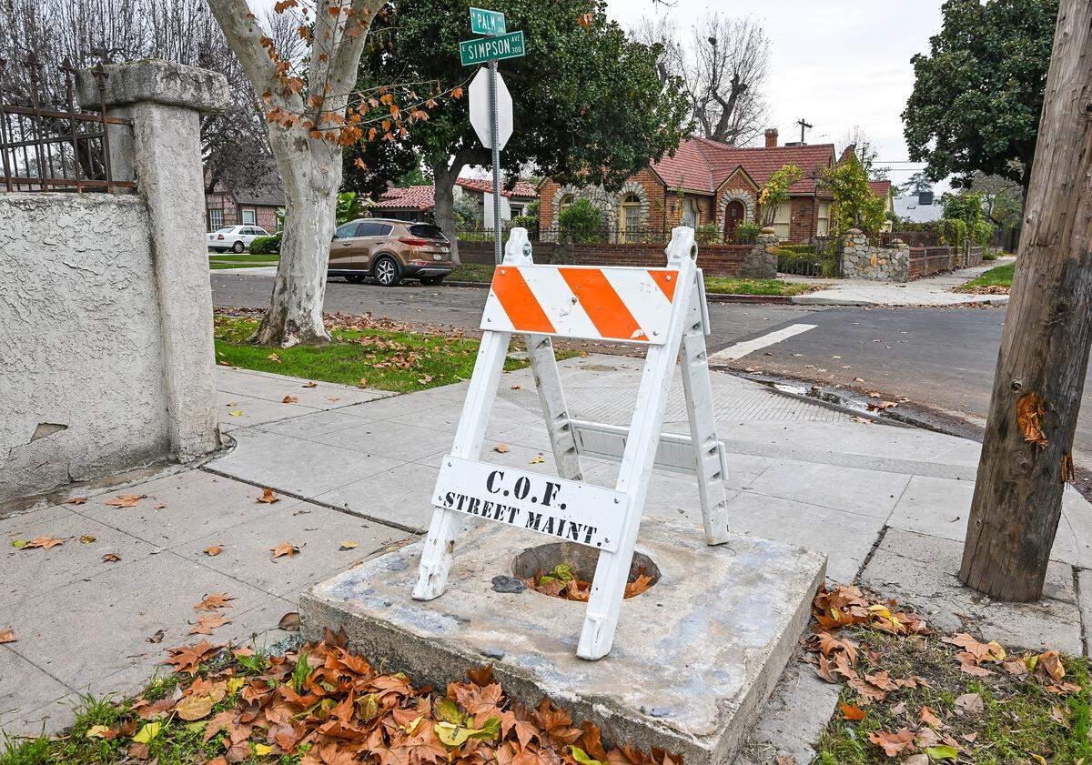 A city barricade stands over what once was one of the Fresno High neighborhood stone pillars after it was struck and destroyed by a vehicle at Palm and Simpson avenues on Dec. 18.