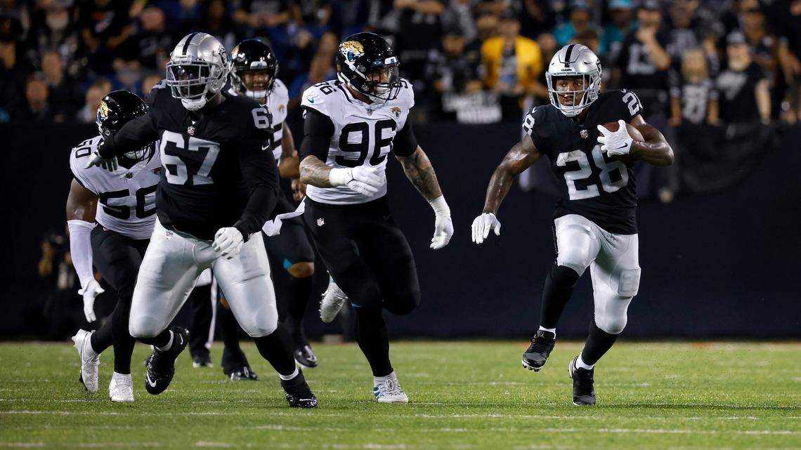 Las Vegas Raiders running back Josh Jacobs runs the ball up the field during an NFL preseason game against the Jacksonville Jaguars, Thursday, Aug. 4, 2022, in Canton, Ohio.