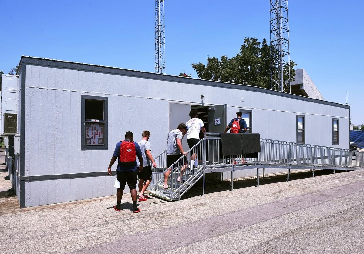 Fresno State football players file into the trailers outside Beiden Field that serve as an athletic dining hall.