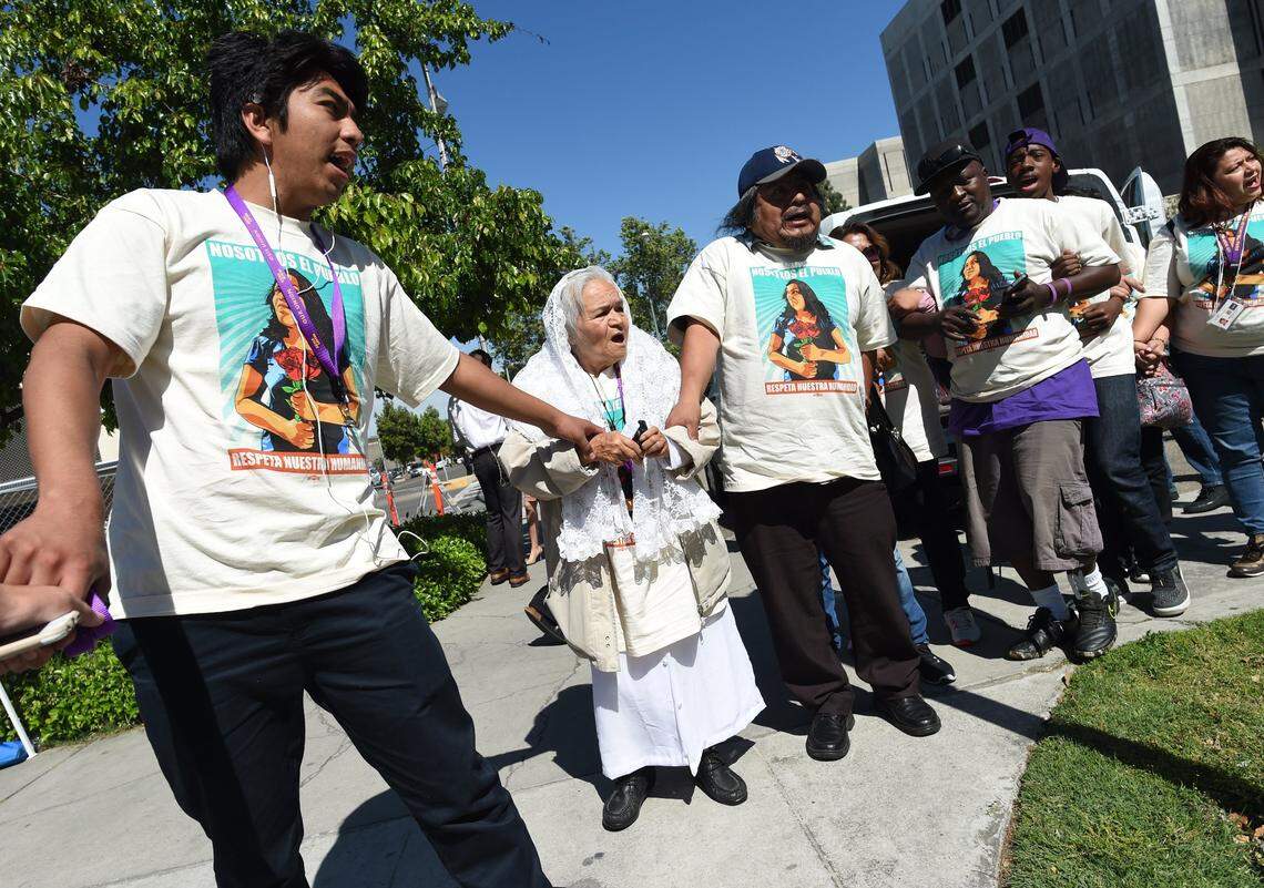 Members of the “Caravan Against Fear” tour to defend immigrant rights, including 79-year-old Petra Ramirez, center, chant as they protest outside Fresno County Sheriff Margaret Mims’ office to protest the sheriff’s collaboration with deportation officials.