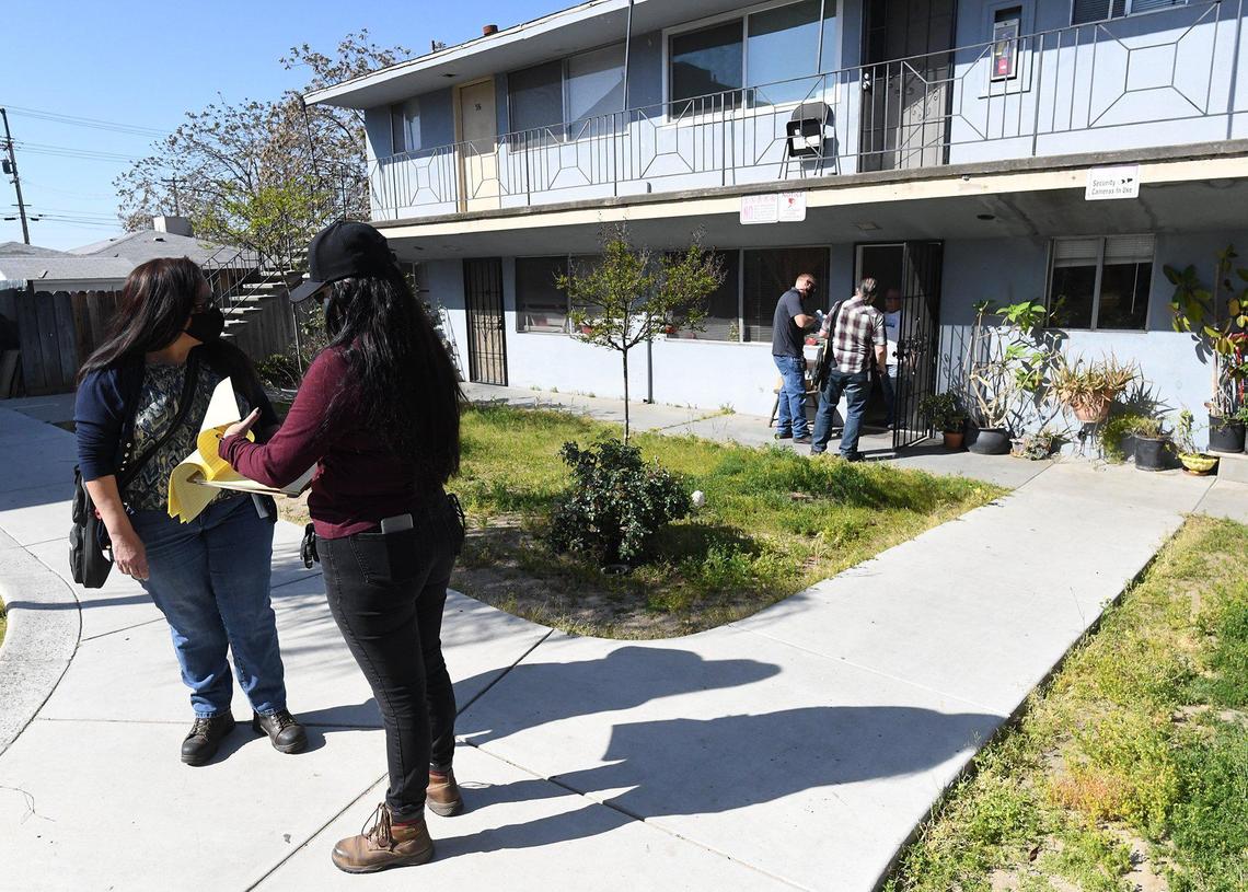 City of Fresno Code Enforcement officers take notes and make the rounds during an inspection of the Manchester Arms complex, March 31, 2021.