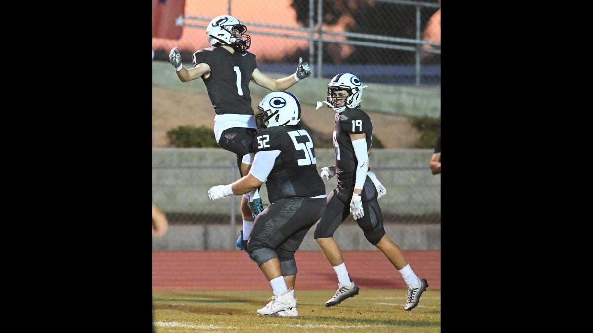File photo of Central Valley Christian’s Bryce Cook, left, celebrating an early touchdown against Clovis North with teammates Tyler Hughes, center, and Caden Ritchie during their game at CVC on Friday, Sept. 8, 2023.