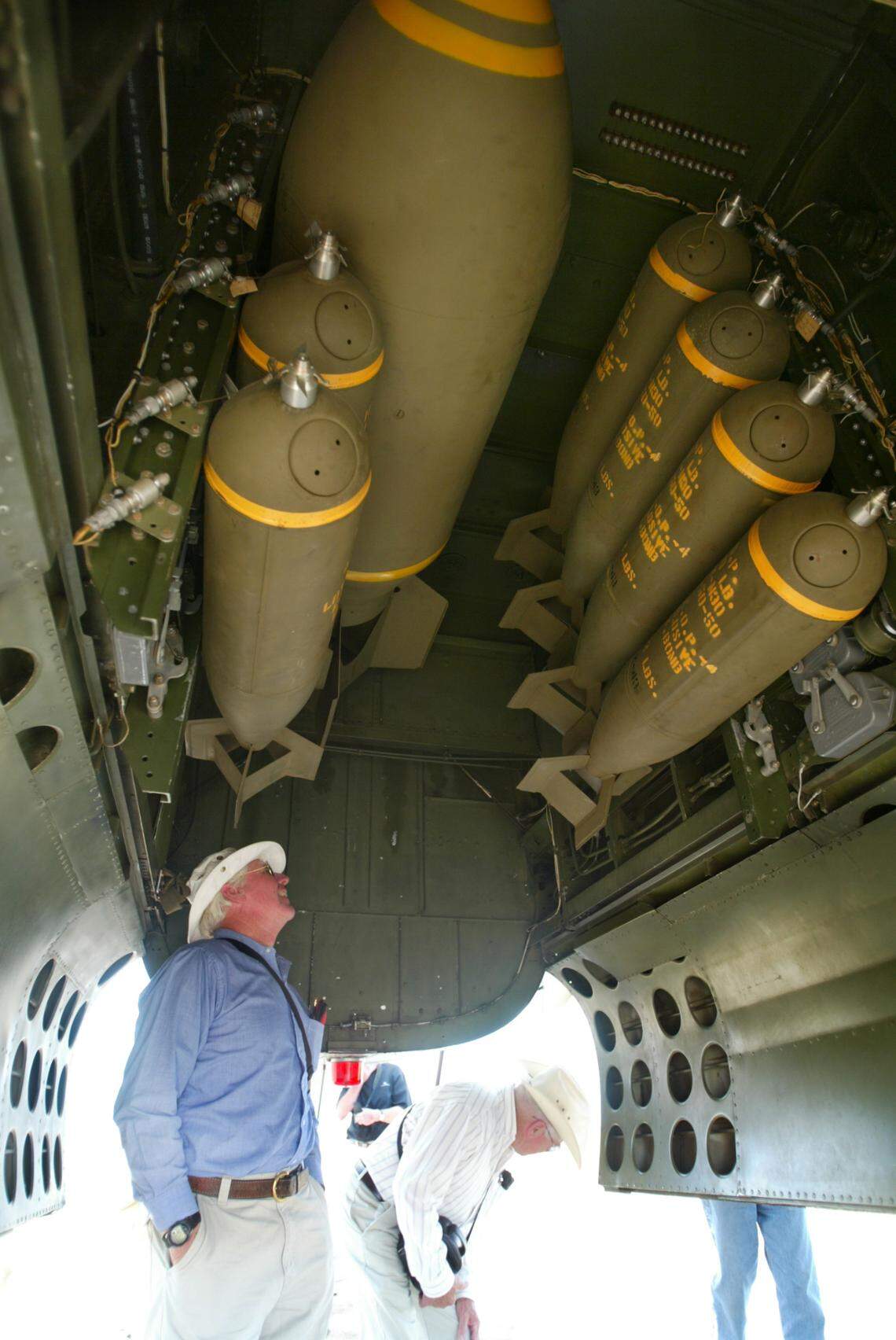 A specator checks out the bomb bay complete with dummy bombs in a B-25 Mitchell bomber that was part of a fly-in at Eagle Field in Dos Palos in June 2007.