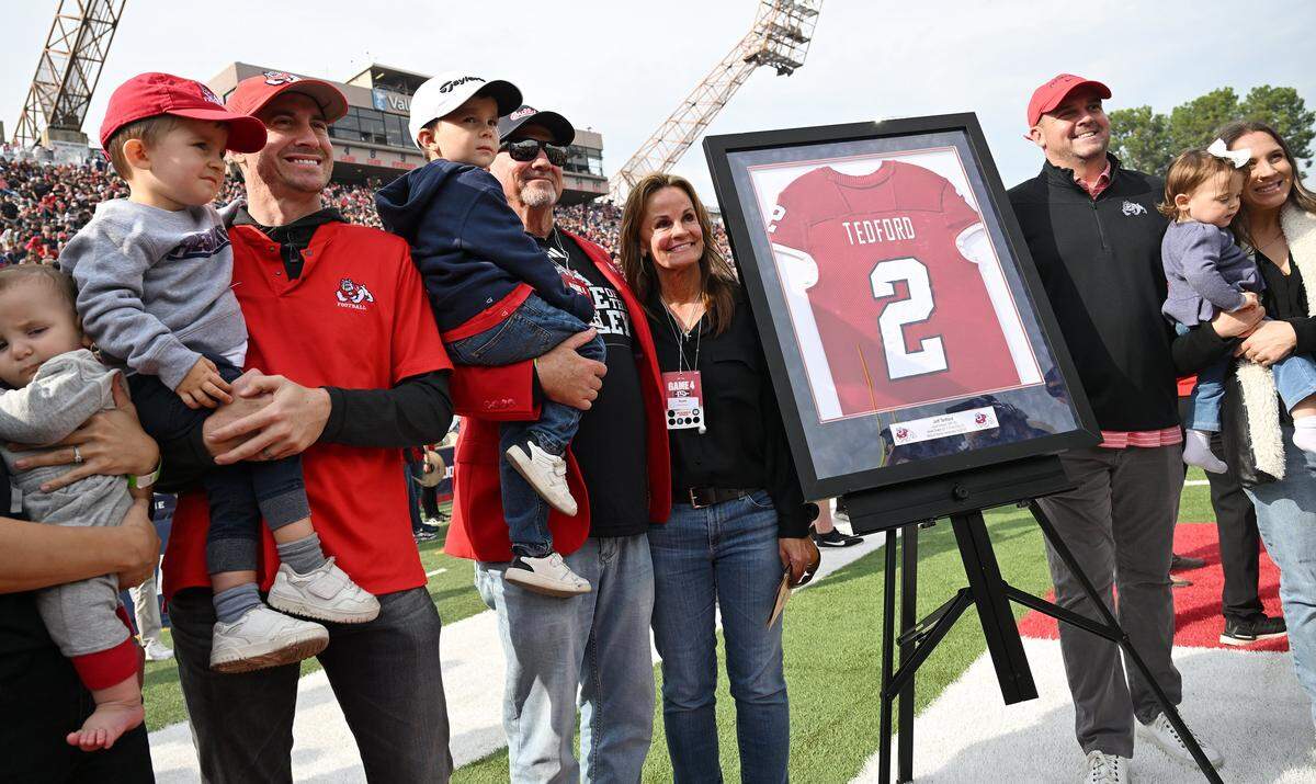 Former Fresno State head football coach Jeff Tedford, center, gathers with his family for a photo after being honored by Fresno State during halftime Saturday, Oct. 24, 2025 in Fresno. 