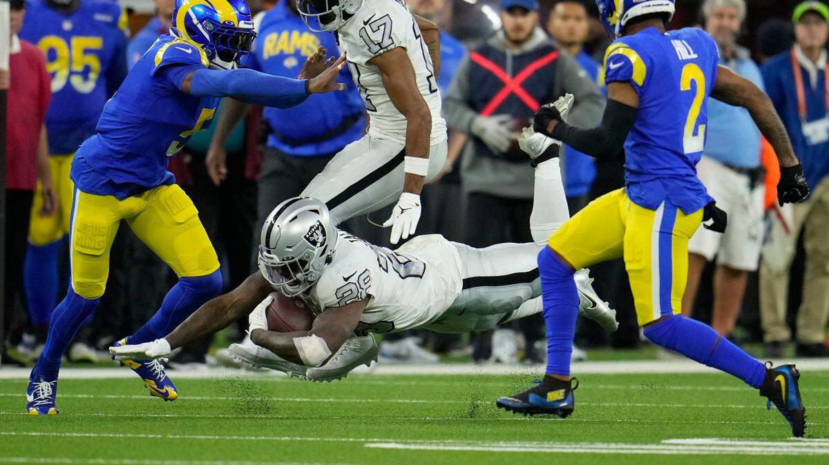 Las Vegas Raiders running back Josh Jacobs dives forward with the ball during the second half of an NFL game against the Los Angeles Rams Thursday, Dec. 8, 2022, in Inglewood, Calif.