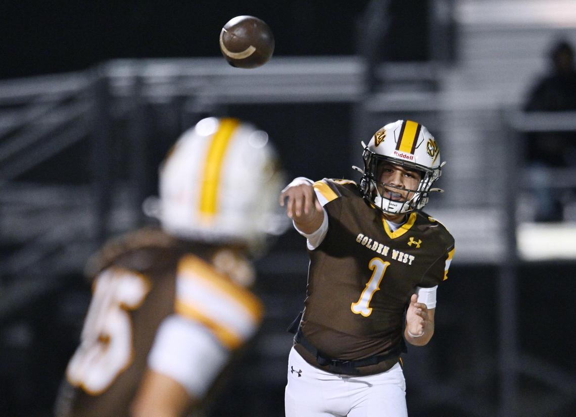 Golden West quarterback Jayden Najera , right, passes to Cadillac Pina, left, in its D2 semifinal championship game against Central Valley Christian Friday night, Nov. 22, 2024 in Visalia.