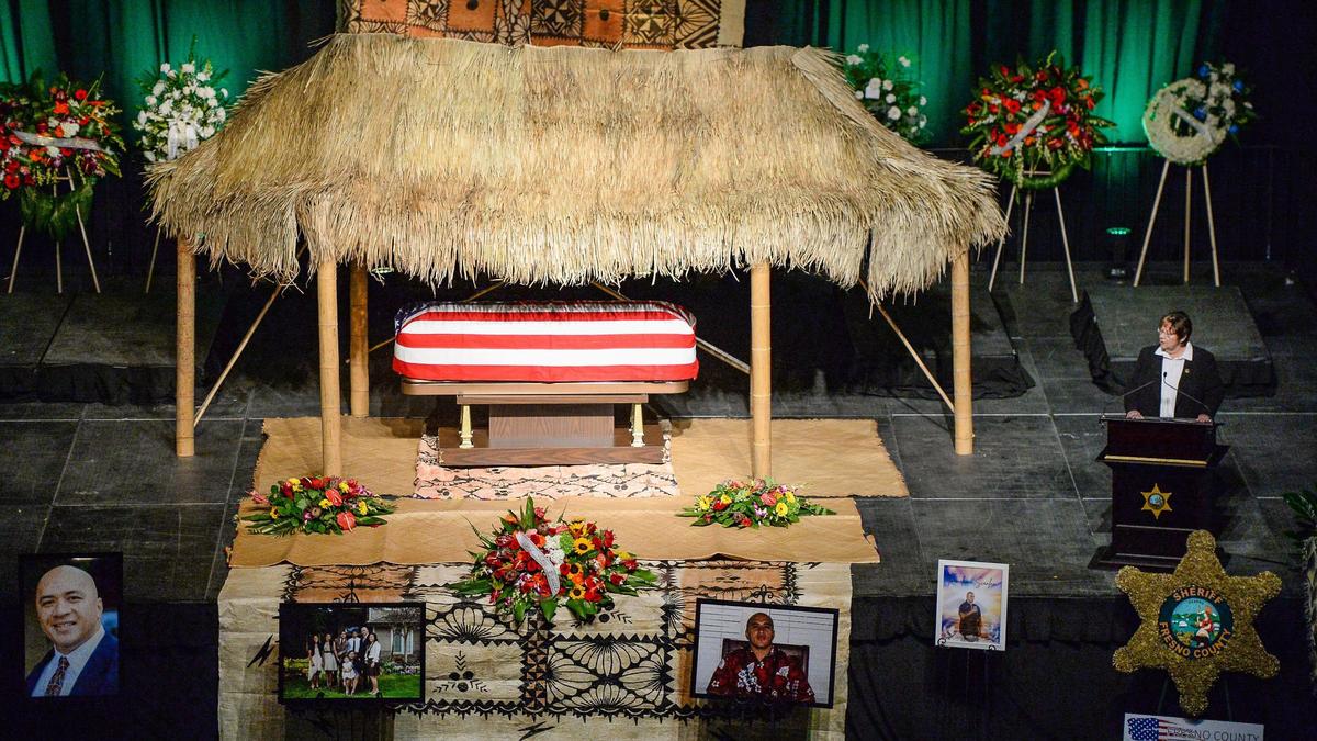 Fresno County Sheriff Margaret Mims, right, gives a eulogy for correctional officer Toamalama Scanlan, during a memorial service at the Save Mart Center in Fresno on Monday, Oct. 25, 2021.