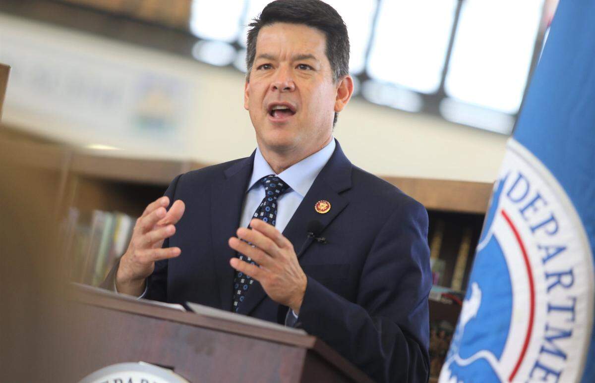 TJ Cox is shown giving a keynote speech in 2019 during his time in Congress. Cox was arrested by the FBI on August 16, 2022 and charged with multiple fraud allegations.