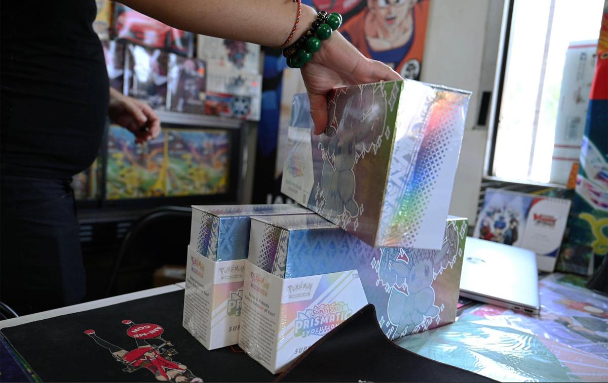 TVN Sports Cards & Collectibles owner Thor Phoeung collects three of the the seven copies of the limited edition Pokemon Prismatic Evolution Super Premium Collection Box he offered through a lottery instead of creating a craze. Photographed Friday, May 16, 2025 in Fresno.