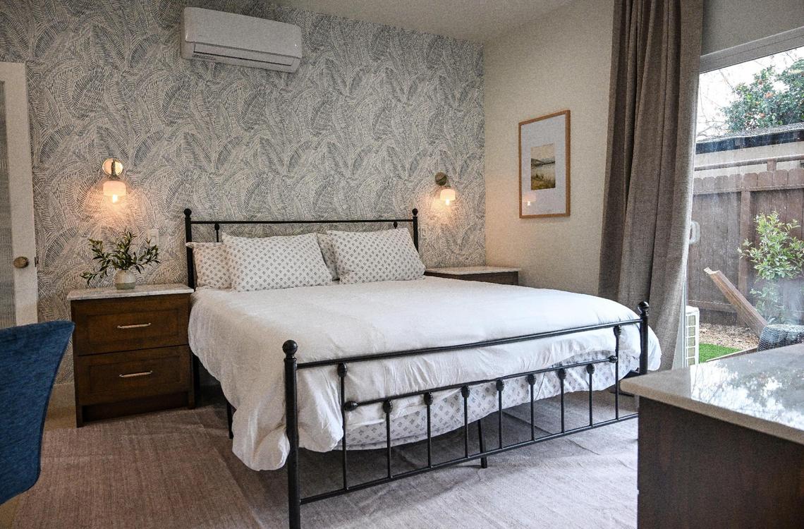 The bedroom space is shown at a recently completed accessory dwelling unit or ADU sitting adjacent to a house on a lot in Fresno neighborhood. Property owner Brandon Telesmanic had the home built as a rental property which is a growing trend in Fresno.