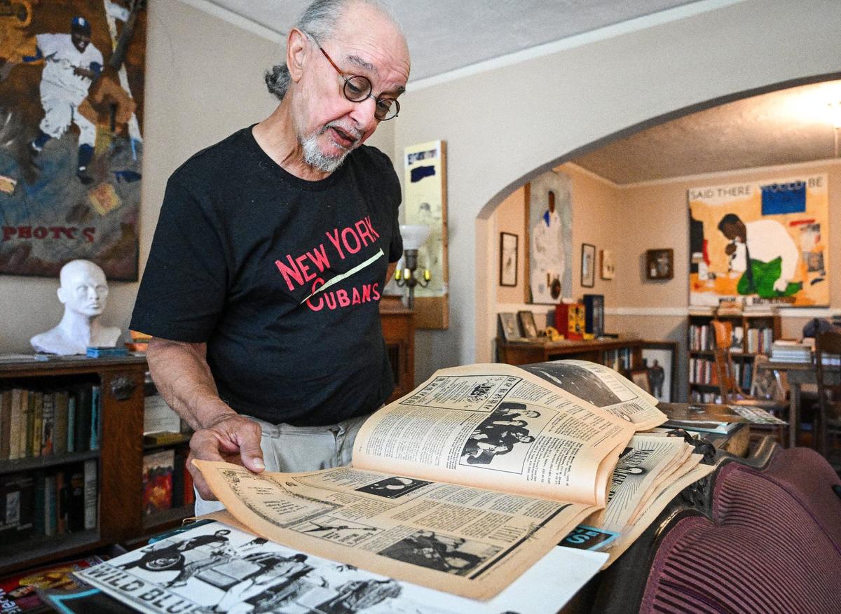 Fresno musician Glen Delpit looks through an old newspaper showing listings of various local bands who played at The Wild Blue Yonder music venue in the Tower District.