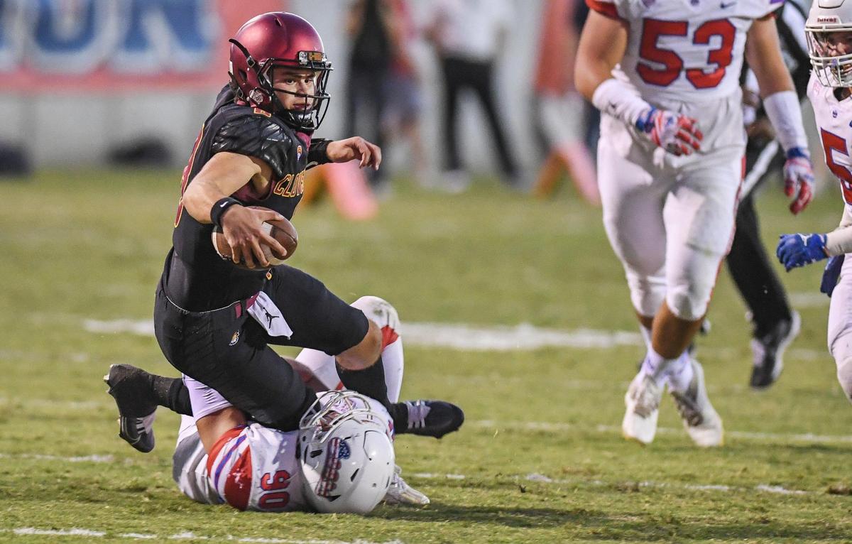 Clovis West quarterback Ryan Markarian scrambles for a few yards before being taking down by Buchanan’s Aaron Nevarez during their game at Lamonica Stadium in Clovis on Friday, Sept. 30, 2022.