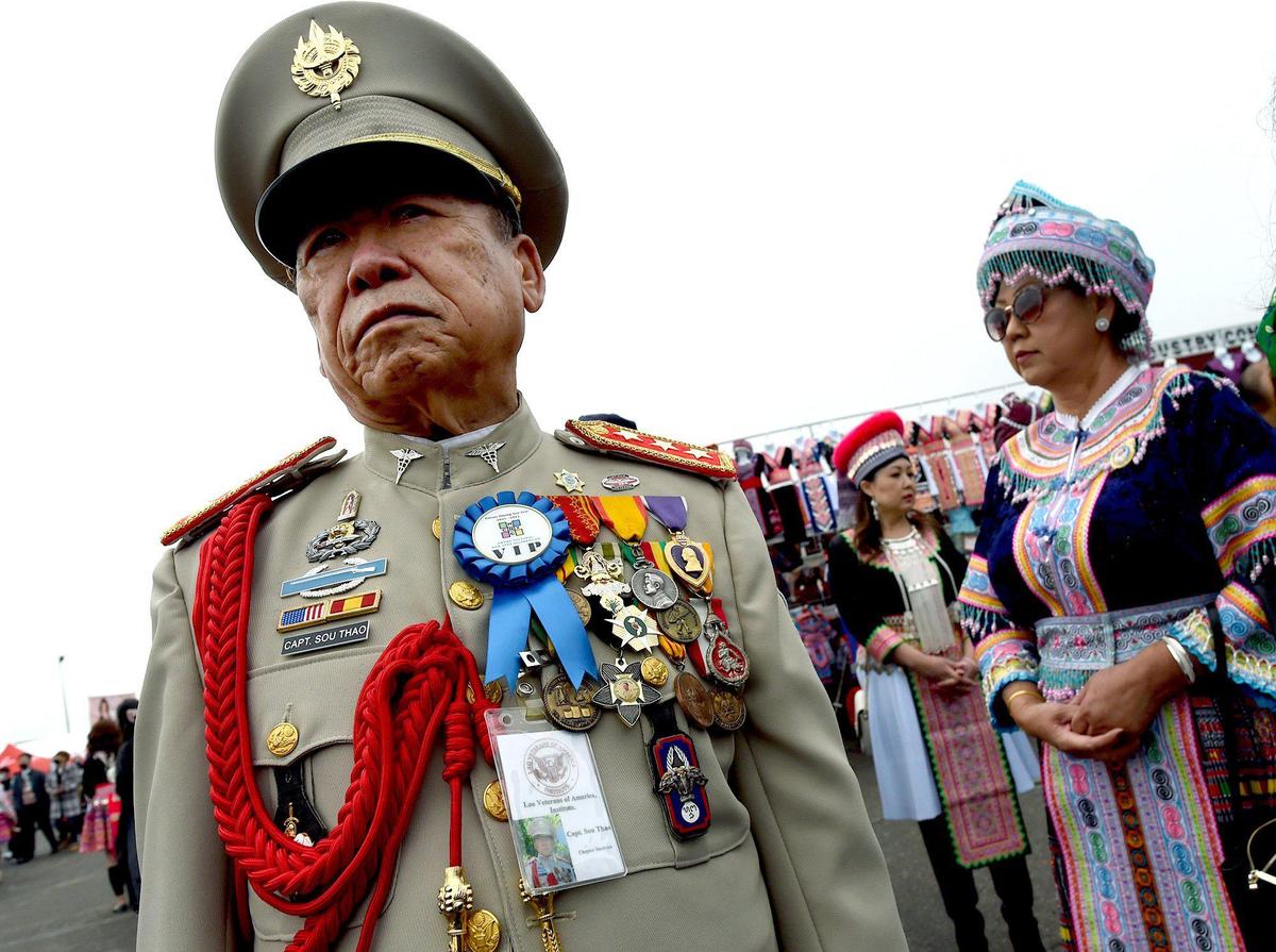 Viet Nam War Army veteran Captain Sou That stands stoically during opening day of the Hmong New Year celebration at the Fresno Fairgrounds, Thursday morning, December 30, 2021.