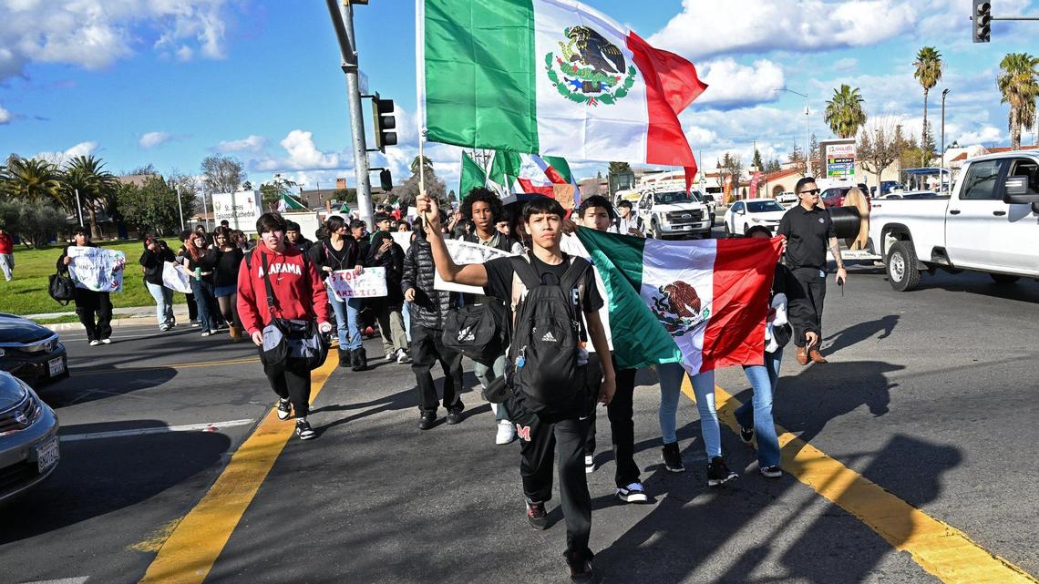 Students from McLane High School cross Dakota Avenue as they march along Cedar Avenue protesting anti-immigration sentiment in the Federal government Friday, Feb. 7, 2025 in Fresno.
