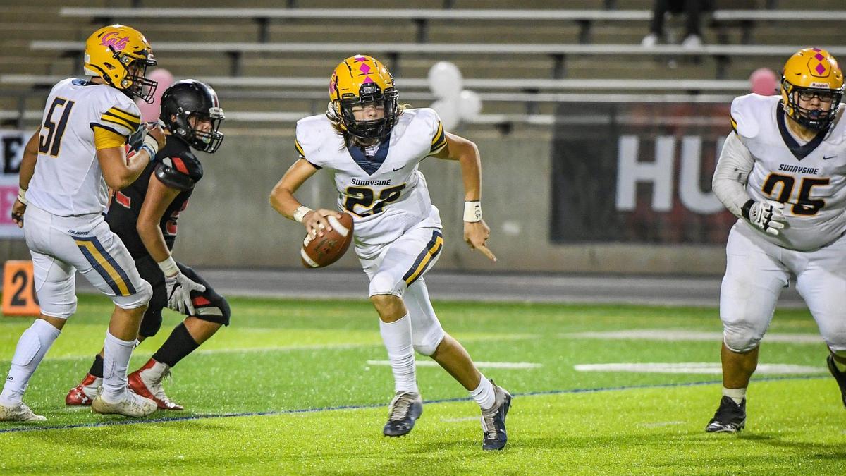 Sunnyside quarterback Tanner Wilson scrambles out of the pocket while looking for a receiver during their game against McLane at McLane High on Friday, Oct. 15, 2021.