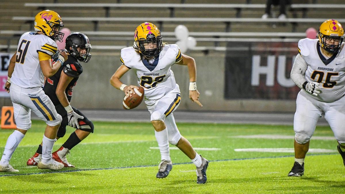 Sunnyside quarterback Tanner Wilson scrambles out of the pocket while looking for a receiver during their game against McLane at McLane High on Friday, Oct. 15, 2021.