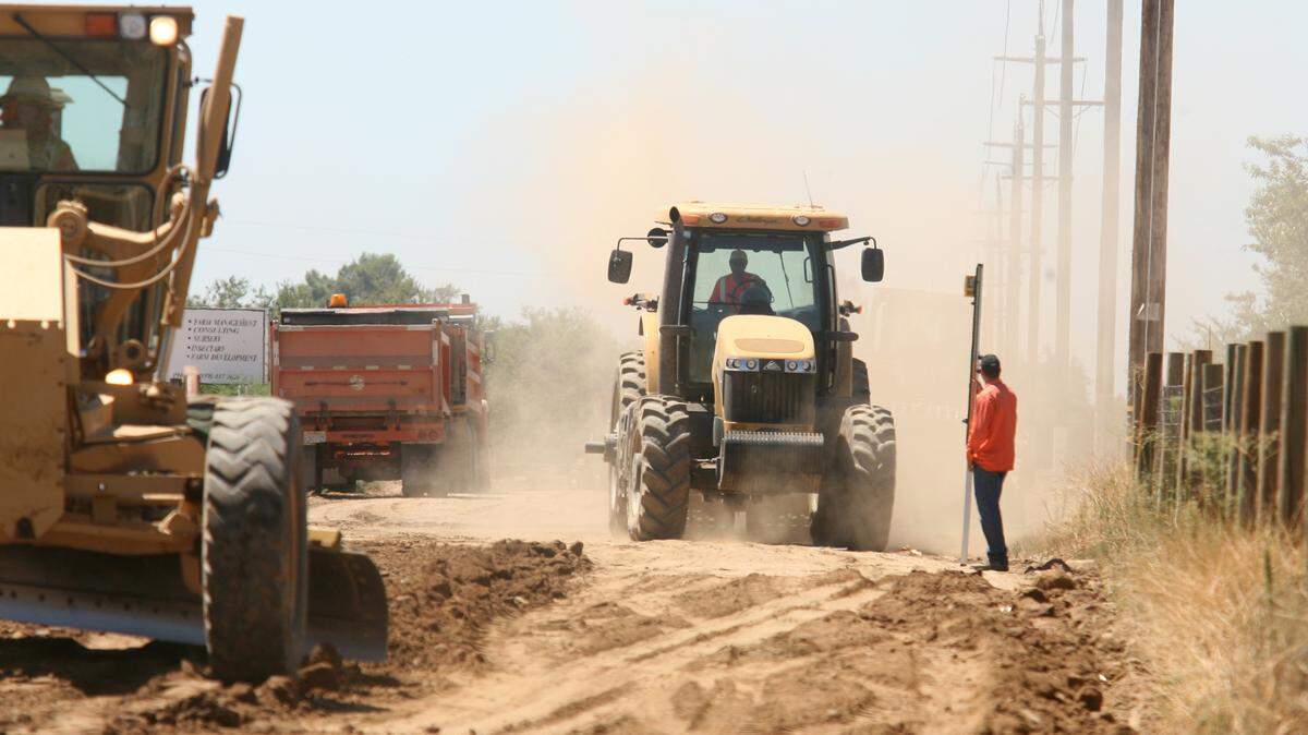 Heavy machinery works the roadbed of Avenue 9, east of Road 36, in this file photo from 2011. Measure T would fund new roadway projects in Madera County if passed by voters, but critics say the process for developing priorities has not been inclusive enough.