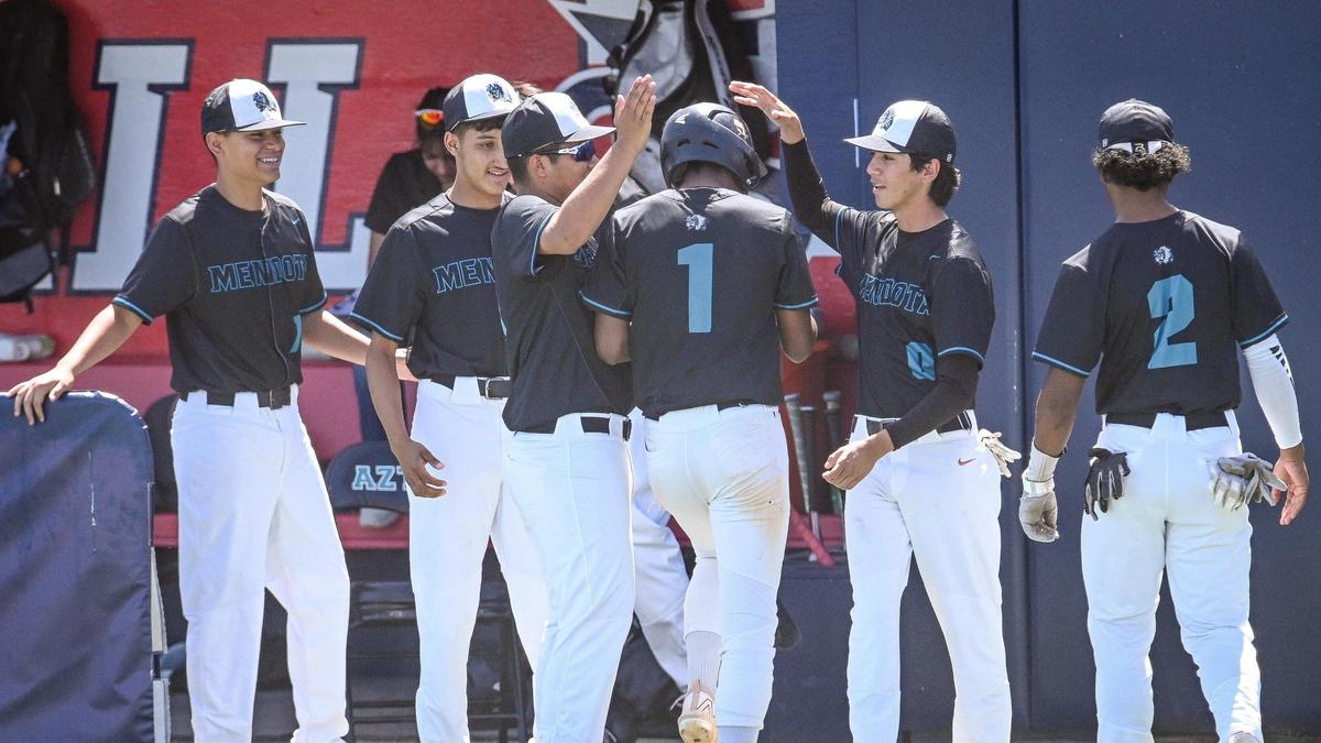 Mendota’s Jeremiah Murphy, center, is congratulated by teammates after scoring when another batter was hit by a pitch with the bases loaded during their Central Section Division VI baseball championship game against Sierra at Pete Beiden Field on Saturday, May 28, 2022.