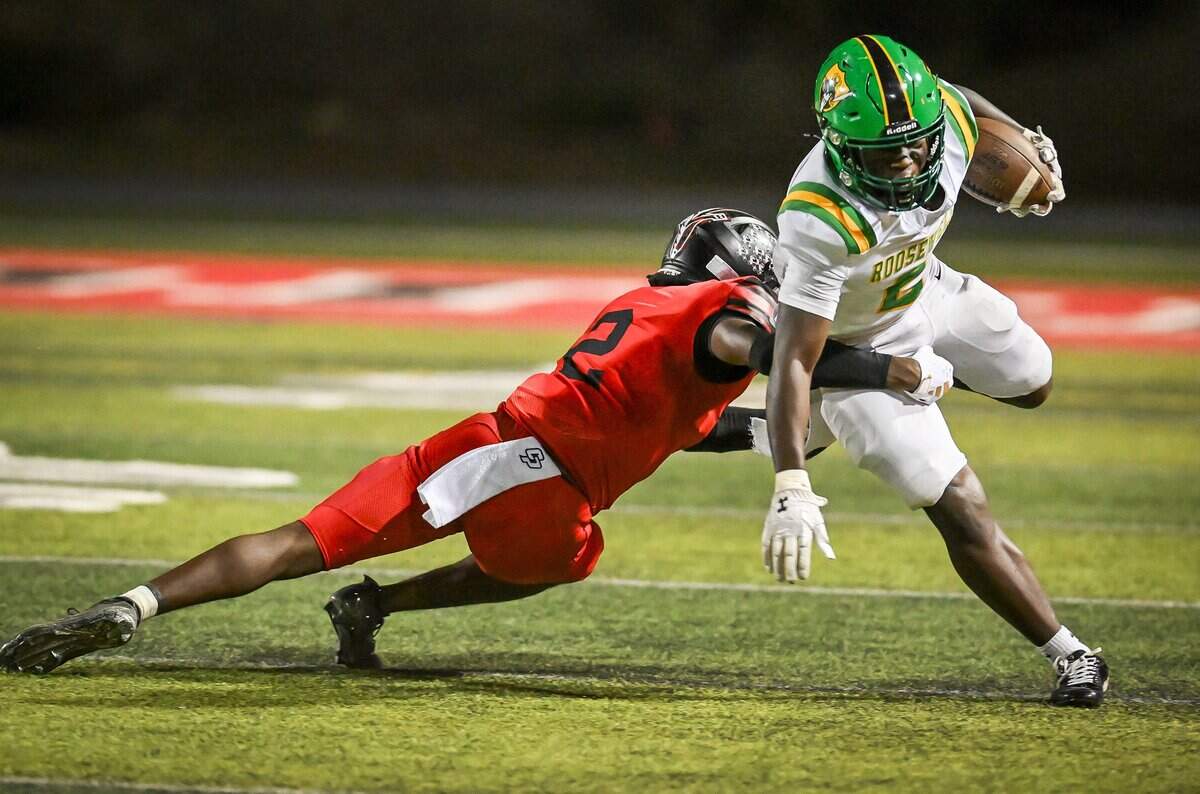 McLane's Demetrius Simon, left, takes down Roosevelt running back Demetrius Simon in the backfield during their North Yosemite League showdown at McLane Stadium on Thursday, Oct. 9, 2025.