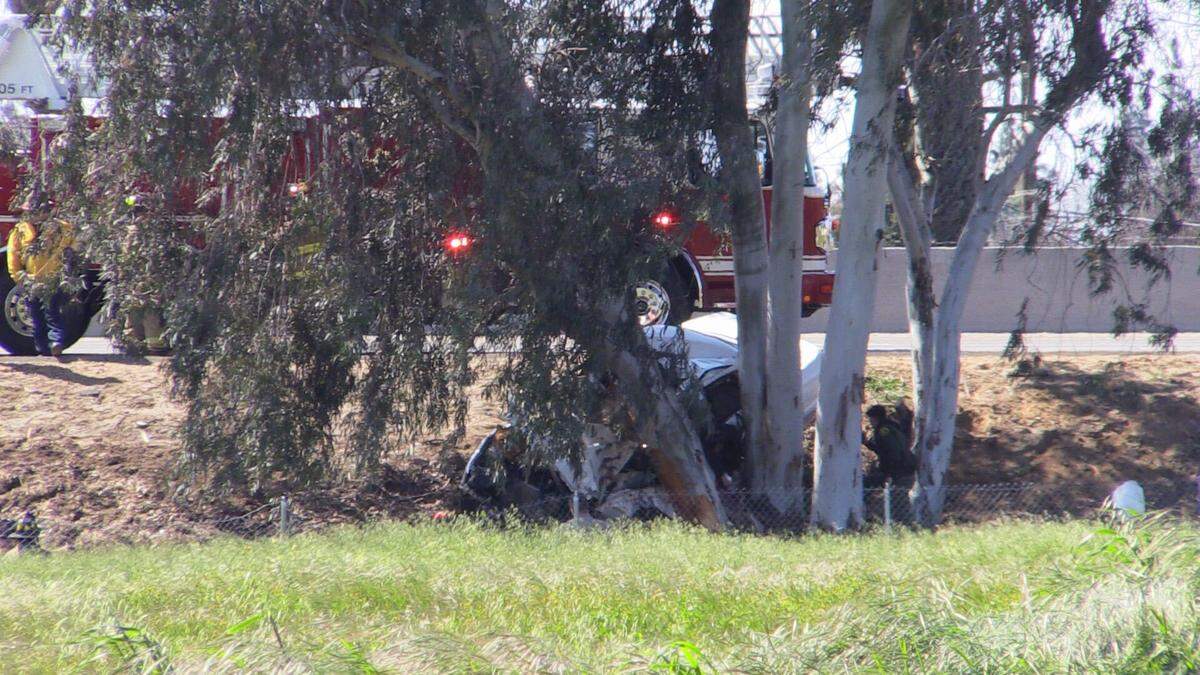 Fresno firefighters attempt a rescue after a vehicle crashed and caught fire Sunday, March 26, 2023 at northbound Highway 99 and the McKinley Avenue offramp.