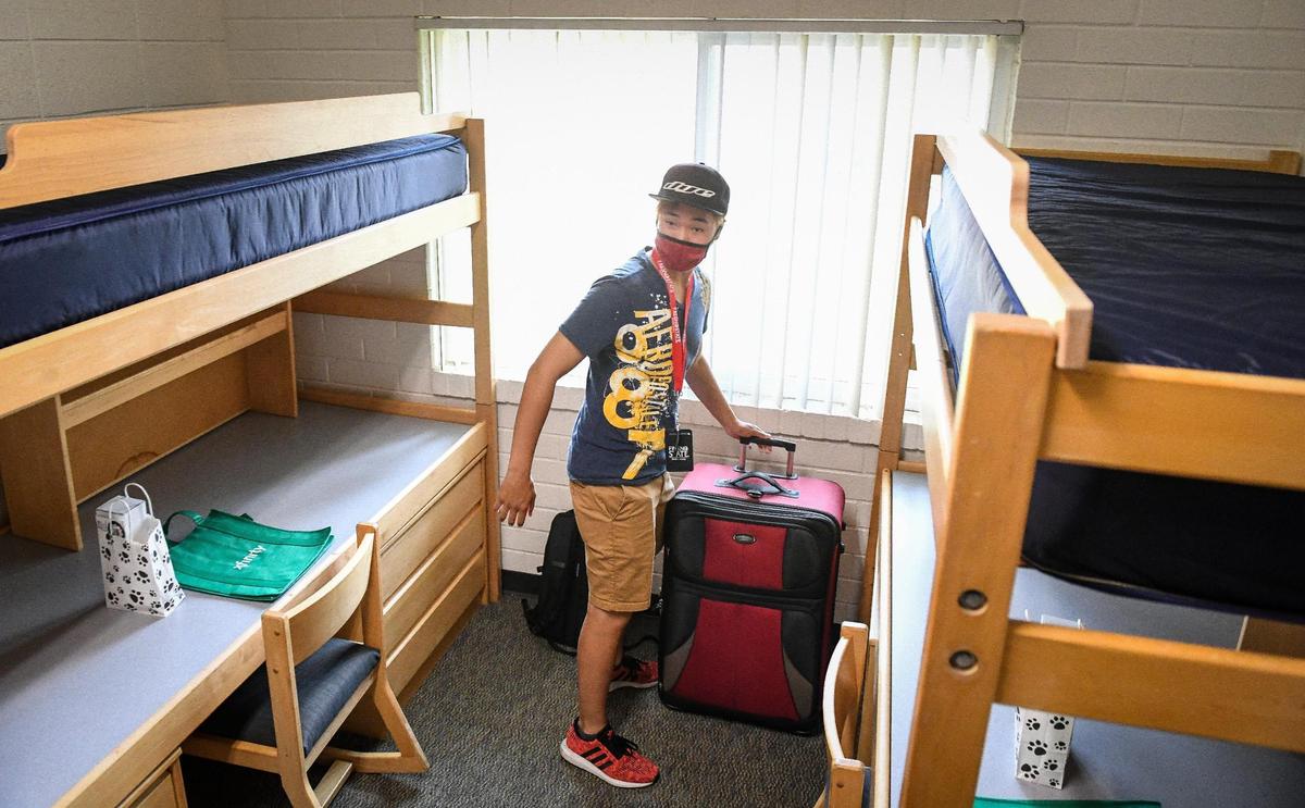 Incoming freshman Justin Tran checks out his new dorm room at Graves Hall in the on-campus housing area at Fresno State on Thursday, Aug. 19, 2021.