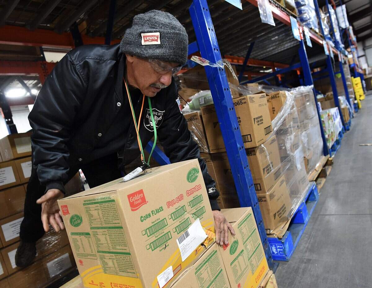 Central California Food Bank volunteer Russell Mesta stacks boxes of food in this 2019 photo. The Food Bank provides critical assistance to Fresno County residents who don’t have enough to eat.