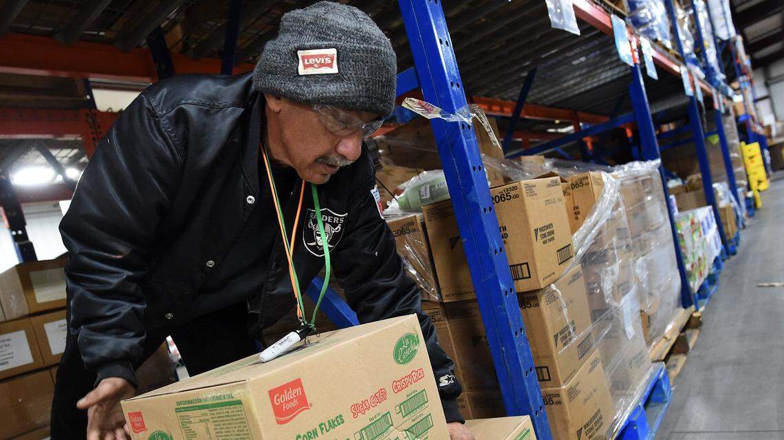 Central California Food Bank volunteer Russell Mesta stacks boxes of food in this 2019 photo. The Food Bank provides critical assistance to Fresno County residents who don’t have enough to eat.