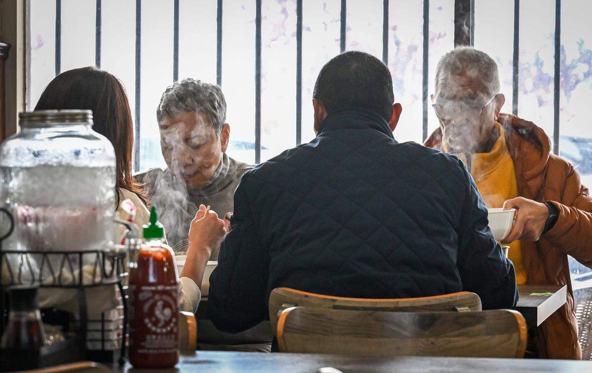 Customers dive into steaming bowls of pho on a cold day at Nho Kitchen in the Mayfair Center at First and McKinley in Fresno on Tuesday, Dec. 2, 2025.