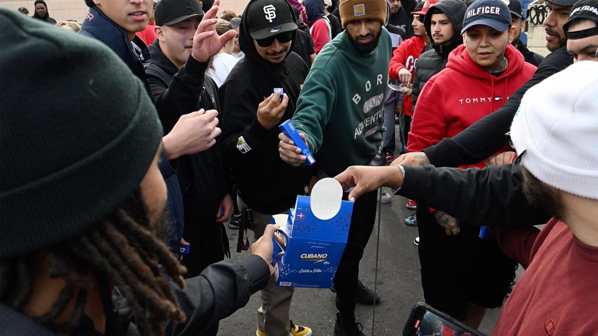 Vibes CUbano rolling paper is handed out for free as hundreds line up at the grand opening of Cookies, Fresno’s newest cannabis dispensary Sunday morning, Dec. 17, 2023. Cookies CEO Berner, born Gilbert Anthony Milam, Jr., was in attendance for the dispensary’s opening which is located at the northeast corner of Blackstone and Shaw avenues.