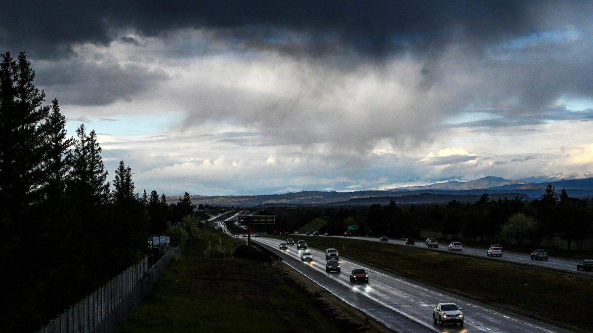 Dark clouds move over Highway 41 at the San Joaquin River in north Fresno before rain showers dampened the commute on in this February 2022 file photo. About 0.17 inches of rain fell at Fresno Yosemite Airport on Friday, March 4, 2022.