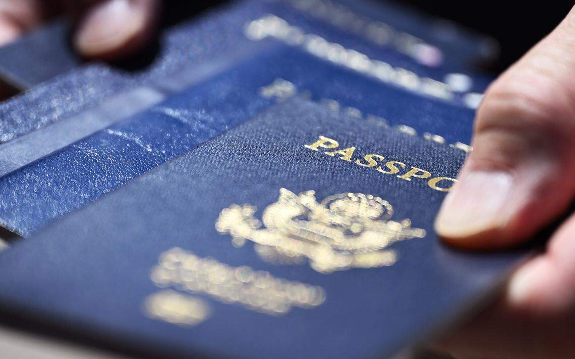 Paul Liu holds a collection of passports he's held over the years. Some Californians are carrying their US passports to avoid ICE profiling and reduce fear of deportation. Photographed Thursday, July 30, 2025 in downtown Fresno.