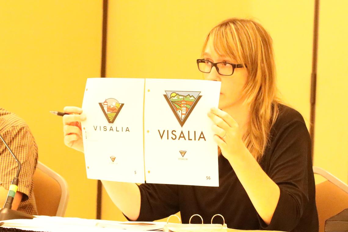 Allison M. Mackey, Communications & Brand Manager for City of Visalia holds two of the 87 submissions received. Entry No. 56 is one of the five tentative entries - No. 7, 34, 35, 56, and 59 - that was compiled Monday night that will be reviewed Wednesday for a “fresh” perspective.