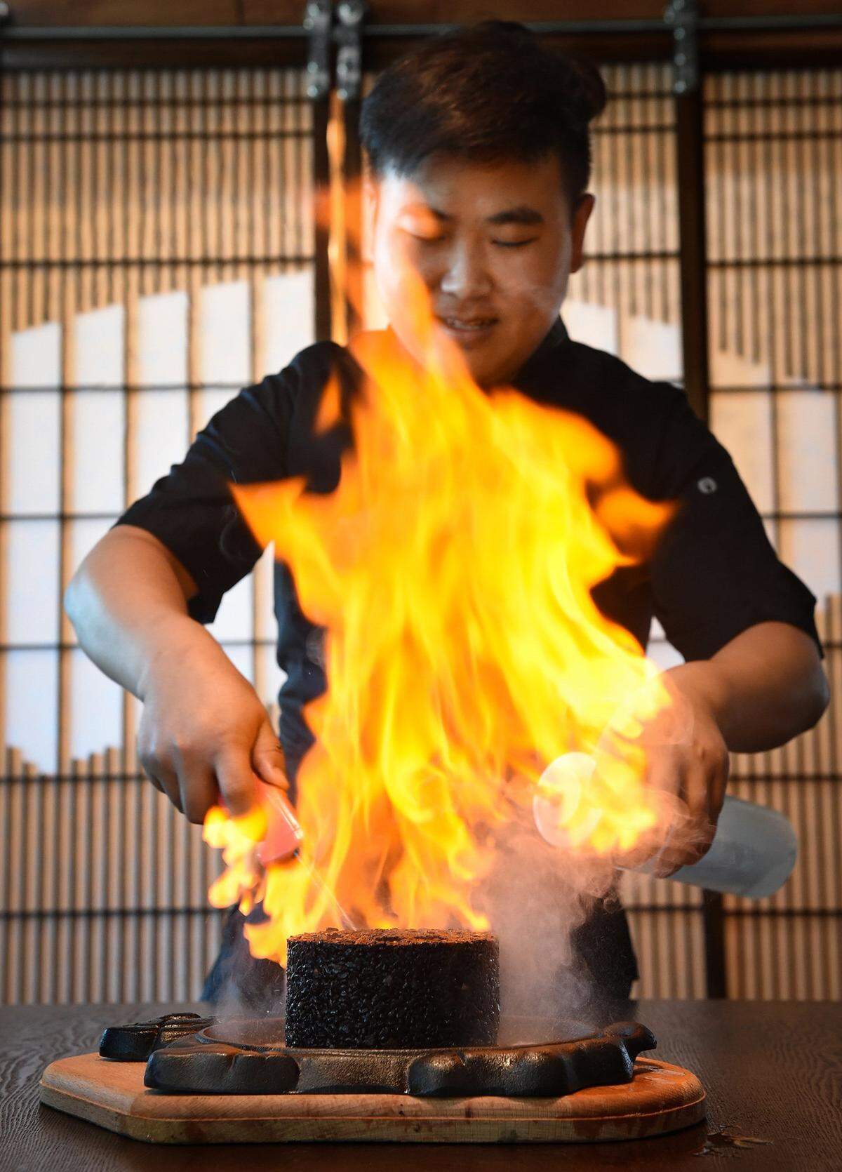 Nami Japanese Cuisine chef Tang sets fire to the Nami Special Fried Rice.