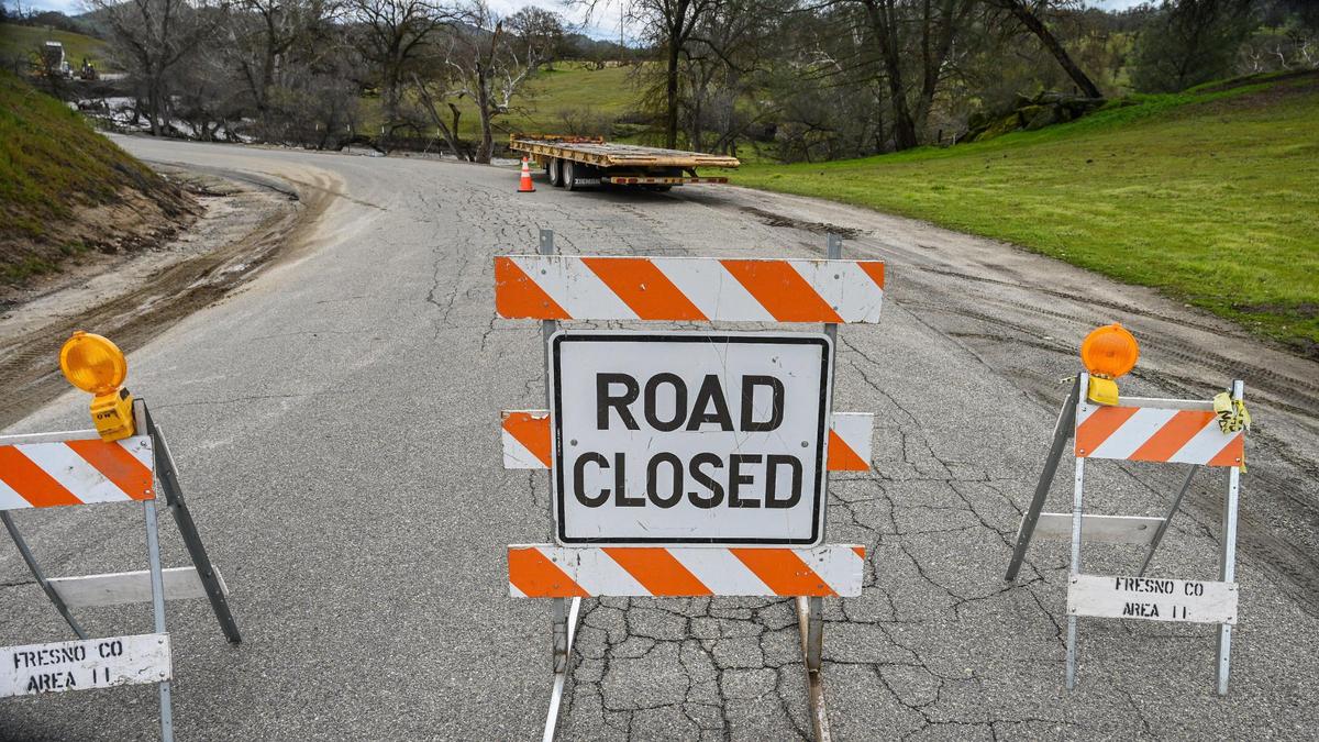 A road closure sign is posted on Old Millerton Road at Ferguson where crews were working to repair the road which was damaged by recent storms, Monday, Feb. 27, 2023.