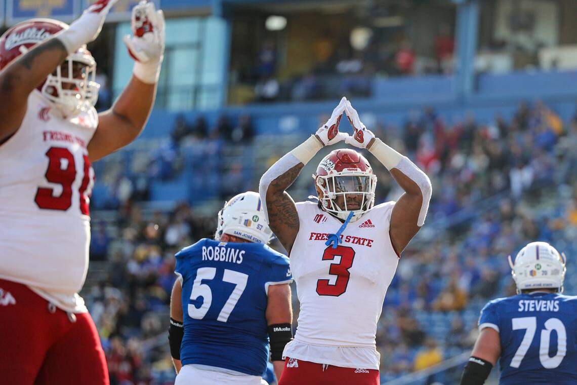 Fresno State defensive end Arron Mosby signals for a safety after Spartans’ quarterback Nick Starkel was penalized for intentional grounding, throwing a pass out of the end zone while under pressure from tackle Ryan Boehm.