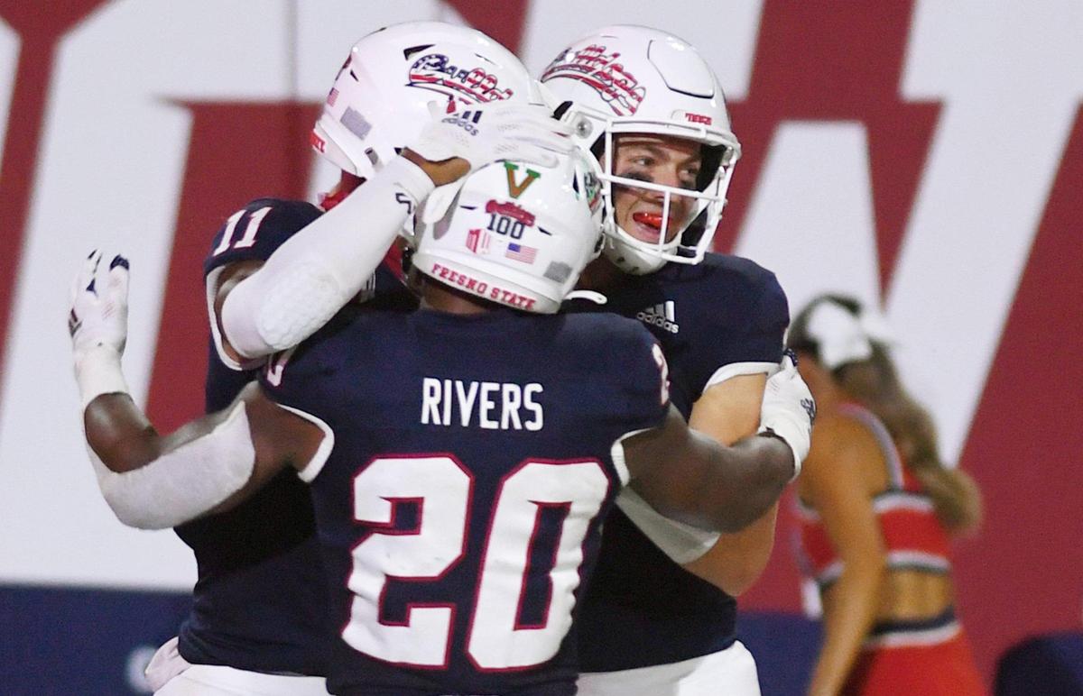 Fresno State running back Ronnie Rivers, center, and quarterback Jake Haener, right, celebrate Josh Kelly’s touchdown, left, against Cal Poly Saturday, Sept. 11, 2021 in Fresno.