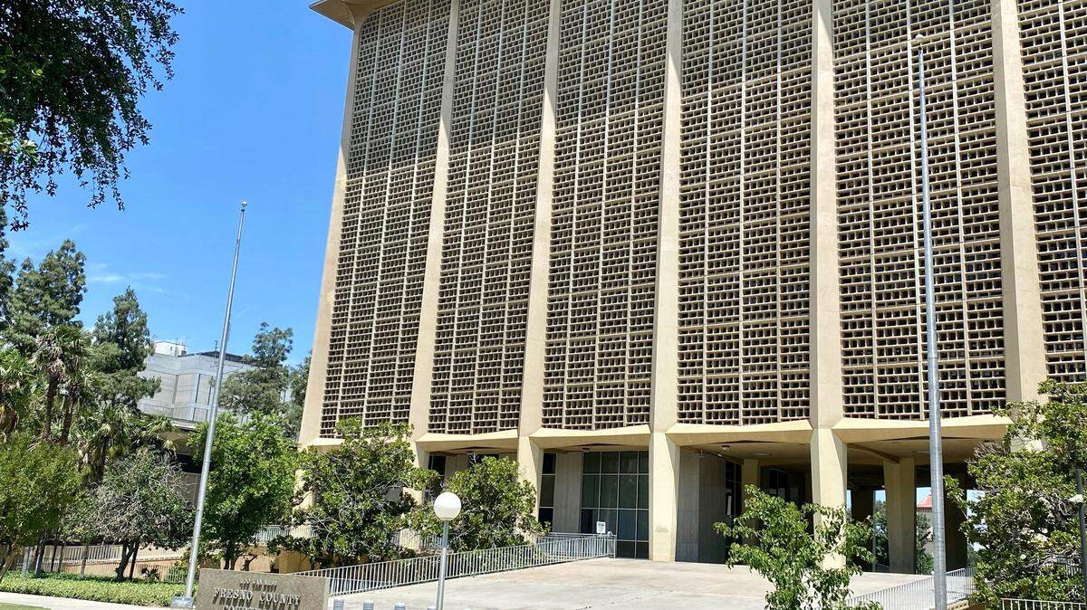 Empty flagpoles flank the sidewalk ramp to the Fresno County Courthouse from Courthouse Park in downtown Fresno on Tuesday, May 23, 2023. A new county ordinance, set to receive a final vote on June 6, would permit only the U.S. flag and California state flag to be flown on official flagpoles at county owned, leased or operated buildings, facilities or parks.