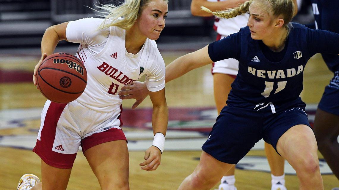 Fresno State guard Hanna Cavinder, left, drives past Nevada’s Kenna Holt, right, Thursday, Jan. 14, 2021 in Fresno. The Bulldogs won 78-70.